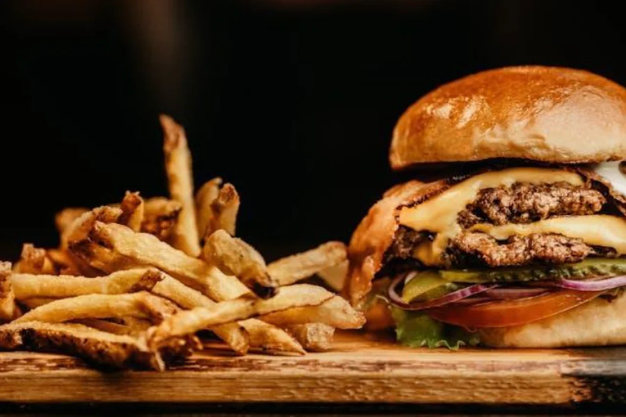 A burger and fries on a wooden board